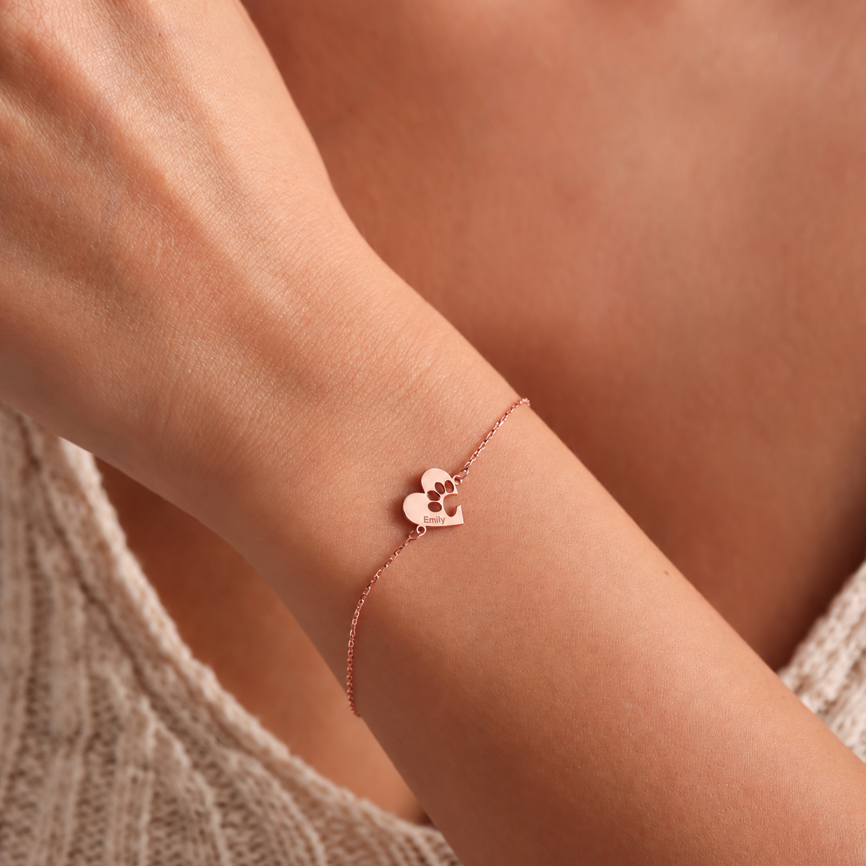 14K rose gold filled pet paw bracelet with a heart-shaped charm engraved Emily, worn on a wrist