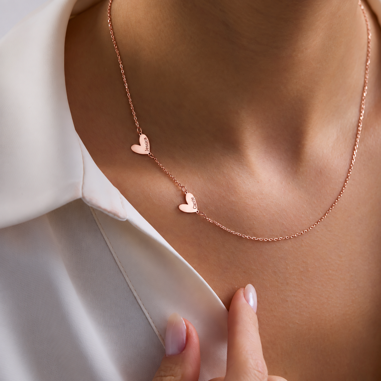 Engraved family heart necklace in 14K rose gold filled, with Jessica and Carrie charms worn with a white shirt