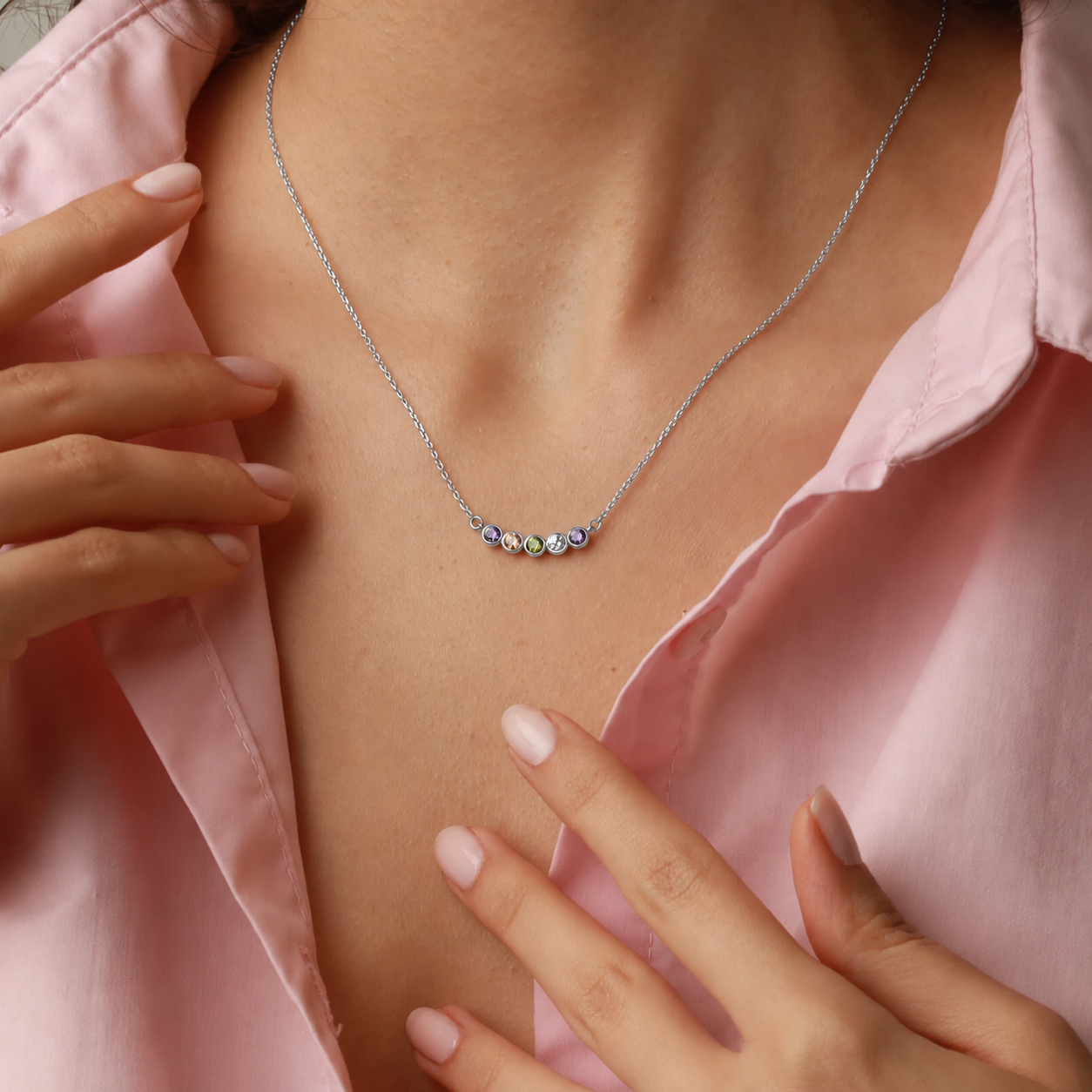 Family birthstone necklace in sterling silver with five colourful gemstones, worn on the neck