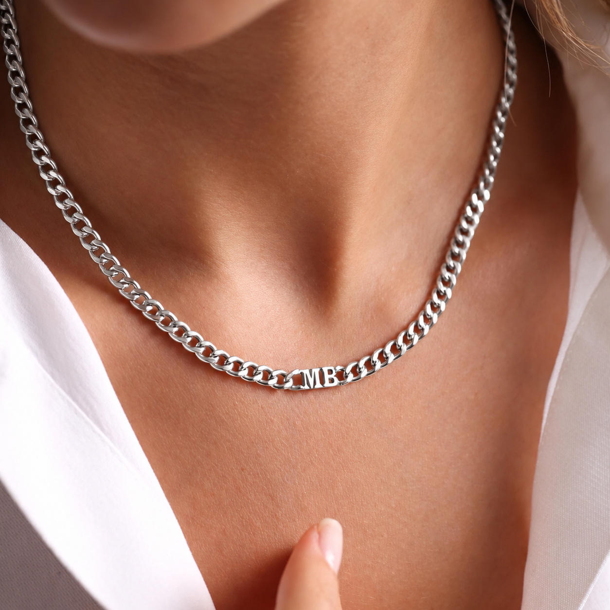 Sterling silver curb-chain choker necklace with MB initials, worn close-up