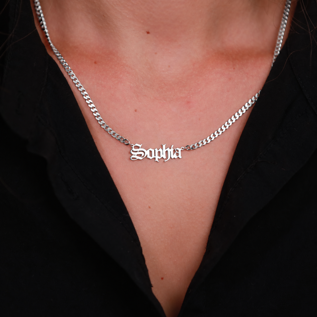Sophia Old English nameplate necklace in 14K solid white gold with a curb chain, worn on the neck